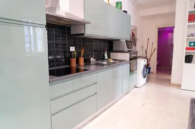 a kitchen with white cabinets and a sink at SvHome in Rome