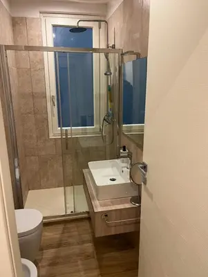 a bathroom with a shower and a sink and a toilet at A un passo dal centro in Rome