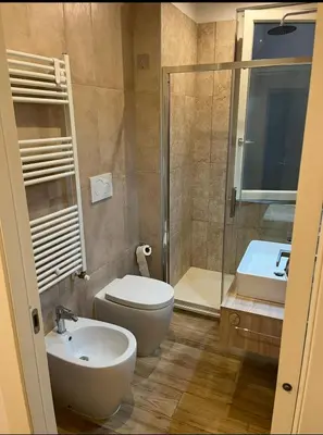 a bathroom with a toilet and a sink and a shower at A un passo dal centro in Rome