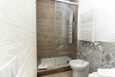 a bathroom with a shower and a toilet and a sink at Silver Suite Coliseum in Rome