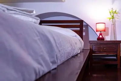 a bedroom with a bed and a night stand with a lamp at Center House Colosseo in Rome
