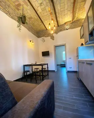 a living room with a couch and a table at Basilica Papale di San Paolo Appartamento Moderno - YOURhOME in Rome
