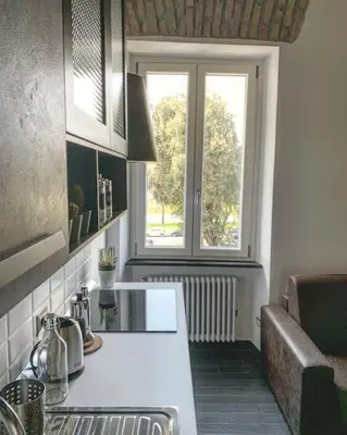 a kitchen with a sink and a window at Basilica Papale di San Paolo Appartamento Moderno - YOURhOME in Rome