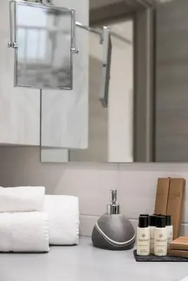 a bathroom with a sink with towels and a mirror at RomeEyes apartment in Rome