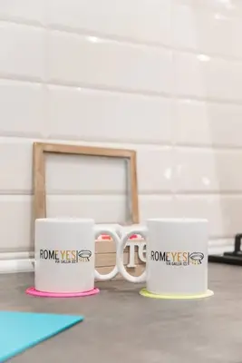 two coffee mugs are sitting on a table at RomeEyes apartment in Rome