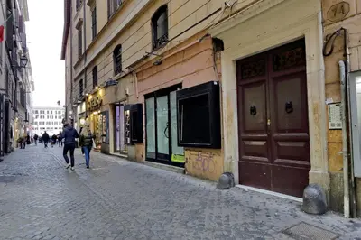 a couple of people walking down a street at Campo dei Fiori Giubbonari Amazing in Rome