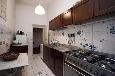 a kitchen with a sink and a stove top oven at Family 2BR Apartment in Via Giulia in Rome
