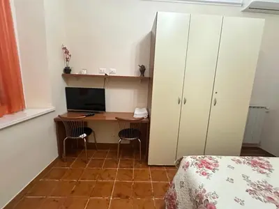 a bedroom with a desk with a computer and a bed at Marcelina in Rome