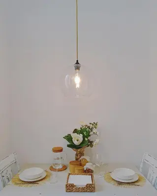 a table with two plates and a vase with flowers at Glory House Trastevere in Rome