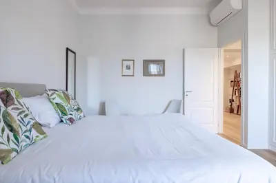 a bedroom with a large white bed with pillows at Top Floor Apt with Rooftop Terrace near St. Peter in Rome