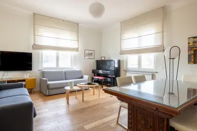 a living room with a couch and a table at Top Floor Apt with Rooftop Terrace near St. Peter in Rome