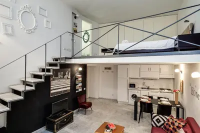 a living room with a staircase leading to a bunk bed at Rome Loft in Rome