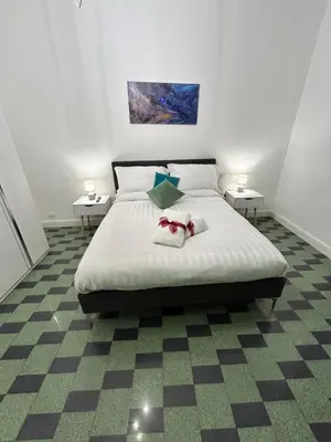 a bedroom with a bed with two towels on it at San Peter Vale House in Rome