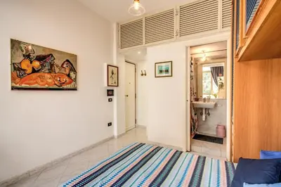 a room with a bed and a bathroom with a sink at Apartment Bentivoglio in Rome