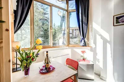 a bedroom with a bed and a table at Apartment Bentivoglio in Rome