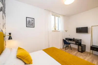 a bedroom with a bed and a desk with a television at The Vista Rooms & Terrace in Rome