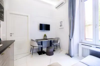 a kitchen with a table and chairs and a window at Rome Deluxe Apartments in Rome