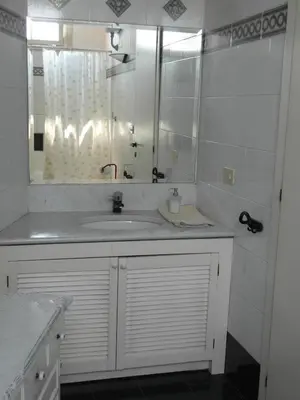 a white bathroom with a sink and a mirror at Abitazione Pigneto B&B in Rome