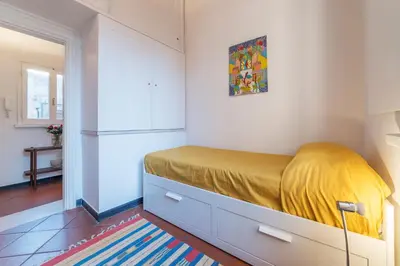 a bedroom with a bed with a yellow blanket at Three bedrooms in world-famous Via Giulia - FromHometoRome in Rome