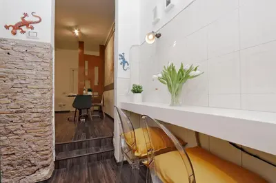 a hallway with a chair and a table at Urbana Delicious Flat in Rome