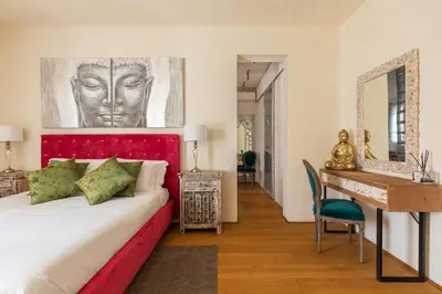 a bedroom with a bed and a desk and a mirror at Relais Clivo Vaticano in Rome