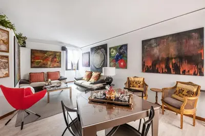 a living room with a table and chairs at Spanish Steps Art Gallery- Roma in Rome