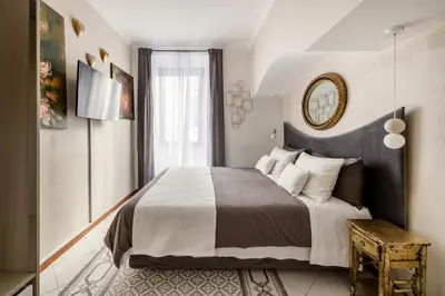 a bedroom with a large bed and a mirror at Spanish Steps Art Gallery- Roma in Rome