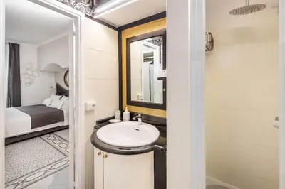 a bathroom with a sink and a bedroom at Spanish Steps Art Gallery- Roma in Rome