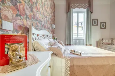 a bedroom with a bed with a book on it at Luxury Stars In Rome - Andromeda apartment in Colosseum in Rome