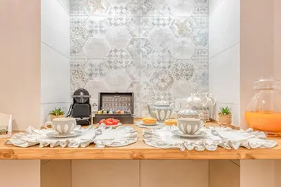 a table with plates and utensils on it at Luxury Stars In Rome - Andromeda apartment in Colosseum in Rome