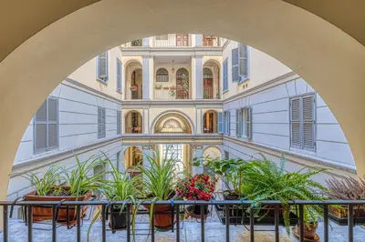 an archway in a building with potted plants at Luxury Stars In Rome - Andromeda apartment in Colosseum in Rome