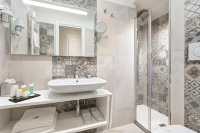 a bathroom with a sink and a shower at Relais de l'Opera Suites in Rome