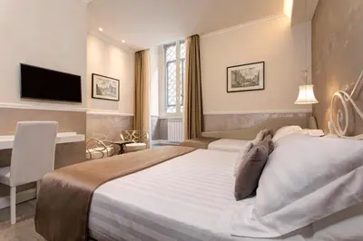 a hotel room with a large bed and a television at Relais de l'Opera Suites in Rome
