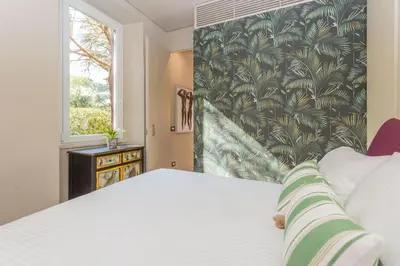 a bedroom with a large white bed and a window at Casa Epiro in Rome