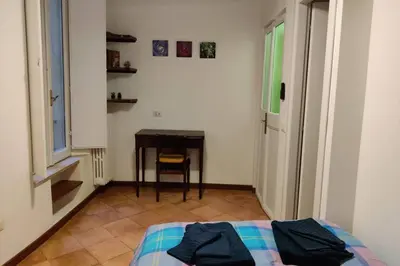 a bedroom with a bed and a table and a desk at Lanza Tomasi Apartment - centre in Rome