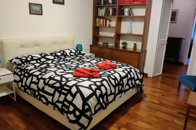 a bedroom with a bed with two red pillows on it at Lanza Tomasi Apartment - centre in Rome