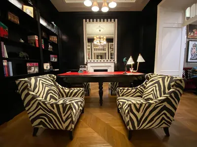 a gaming room with a table and two chairs at Maalot Roma - Small Luxury Hotels of the World in Rome