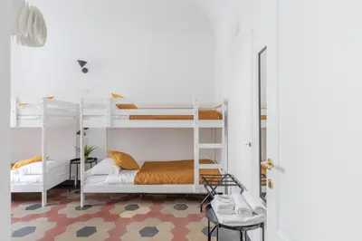 a room with two bunk beds and a chair at iFlat Lovely Apartment for Groups in Rome
