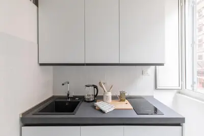 a kitchen with a sink and a counter top at iFlat Lovely Apartment for Groups in Rome