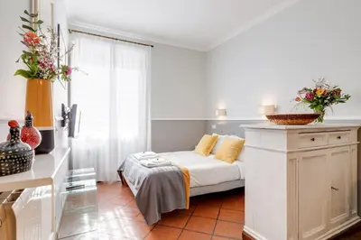a white room with a bed and a window at Rome As You Feel - Paradiso Apartment in Rome