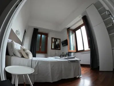 a bedroom with a bed and a table at EMI's Guest House in Rome
