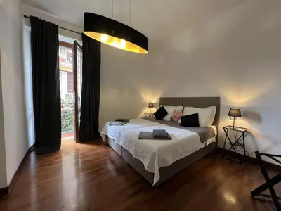 a bedroom with a bed and a large window at EMI's Guest House in Rome