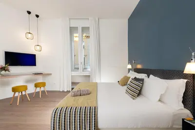 a bedroom with a large white bed and a desk at Charme 308 in Rome