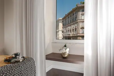 a white room with a window with a table and a table at Charme 308 in Rome