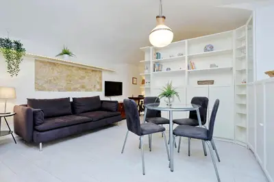 a living room with a couch and a table and chairs at Relax Chiavari House in Rome