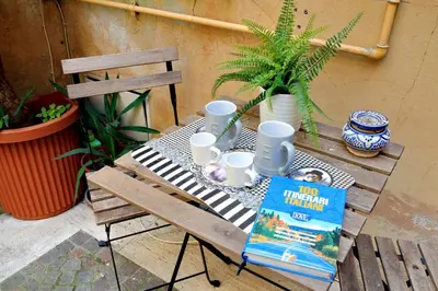 a picnic table with mugs and a book on it at Relax Chiavari House in Rome