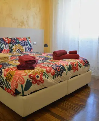 a bed with a colorful blanket and pillows on it at Sophie's Choice 2 a San Pietro in Rome