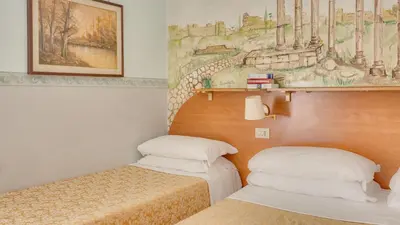 a room with two beds and a painting on the wall at Hotel Washington in Rome