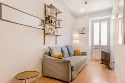 a living room with a couch and a table at BBHOME Comfort apartment near Colosseum in Rome