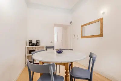 a dining room with a table and chairs at BBHOME Comfort apartment near Colosseum in Rome